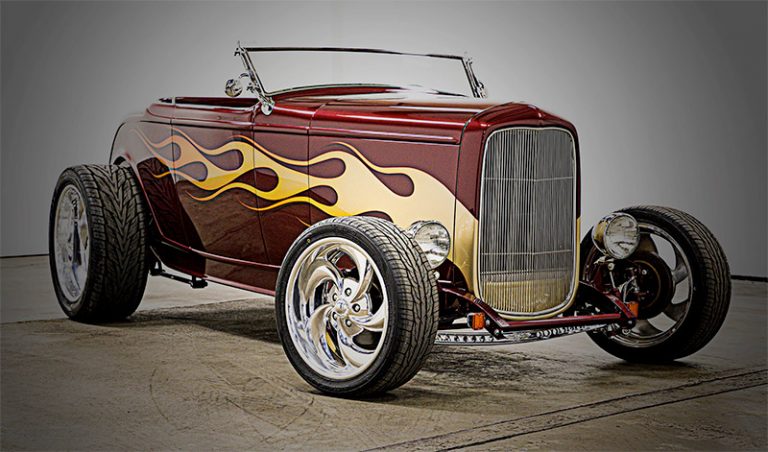 photo of maroon 1932 ford roadster with yellow flames painted on the side