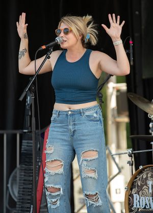 female singer with hands raised