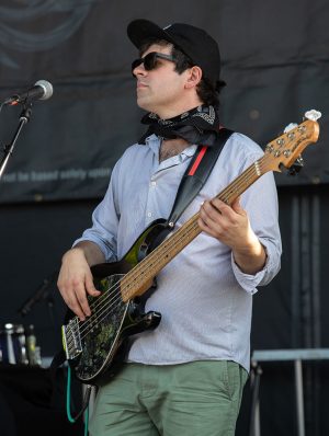 young adult male electric bass player