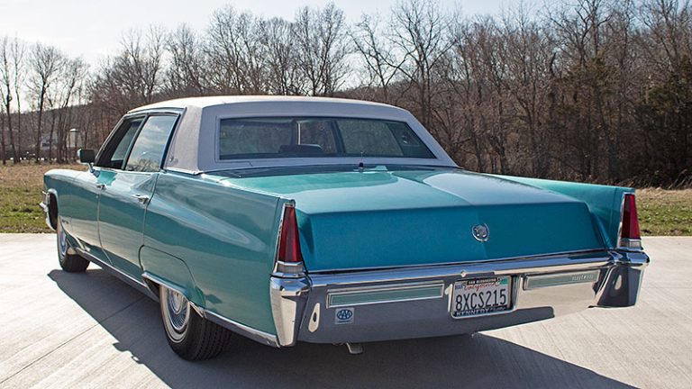 exterior photo of turquoise 1969 Cadillac Fleetwood from driver's side rear corner