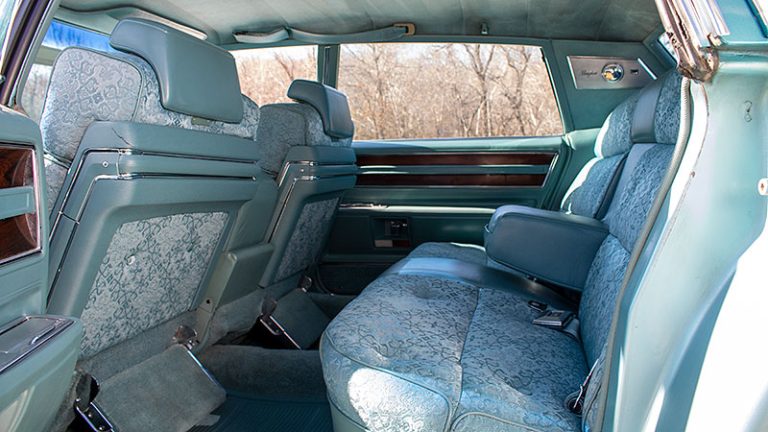 interior photo of turquoise 1969 Cadillac Fleetwood showing fancy upholstery